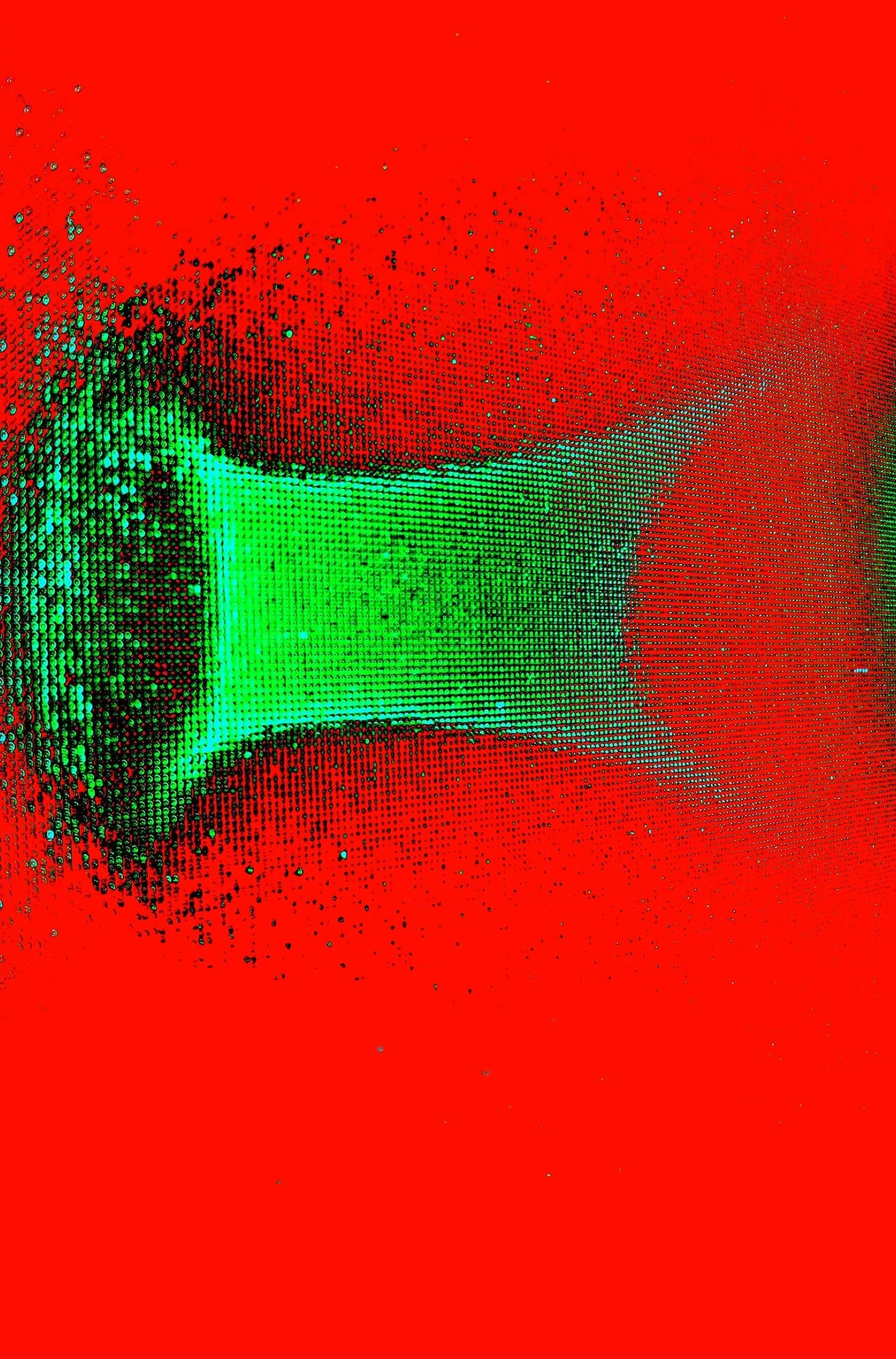 Abstract photograph: a translucent green band stretched across a vivid red field, dissolving into fine particles at its left edge.