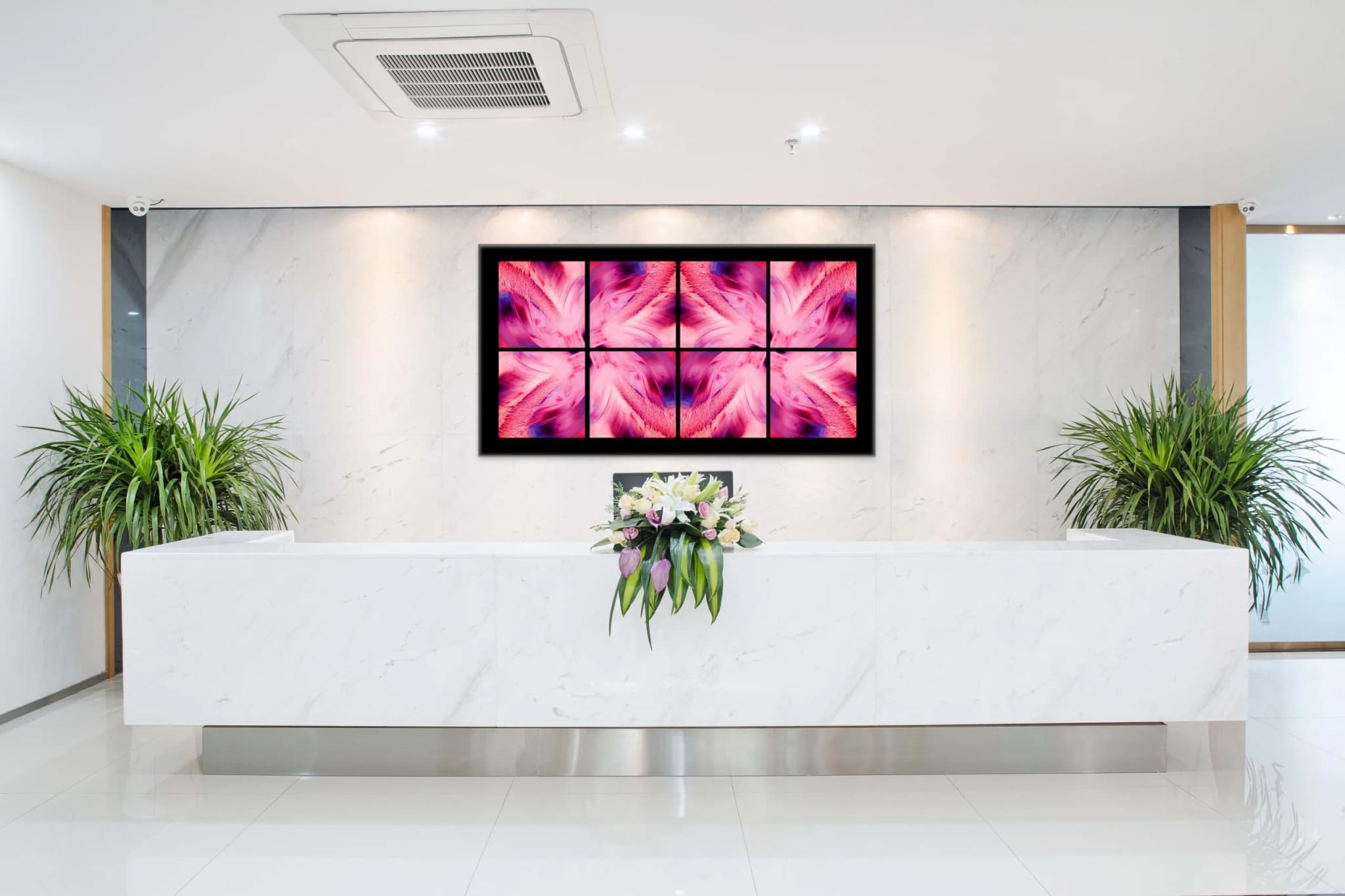 Abstract photograph in deep carmine and magenta: an organic form mirrored symmetrically into a folded, chamber-like structure. Placed in modern white lobby